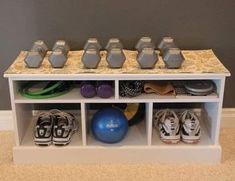 a white shelf with several pairs of shoes on top of it and two blue balls in the middle