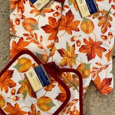 three autumn leaves placemats with tags on them sitting on the floor next to each other