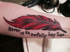 a person with a tattoo on their arm that says never is an awfully long time