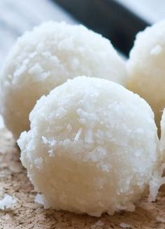 three white sugar balls sitting on top of a cork board table next to each other