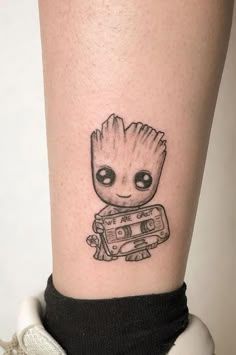 a small tattoo on the leg of a person with a camera in front of them