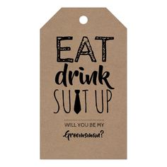 a tag that says eat drink suit up