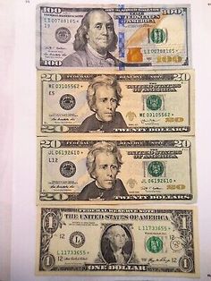 three dollar bills sitting on top of each other