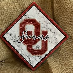 there is a patch with the letter q on it in red and white marbled