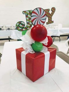 a red present box sitting on top of a table