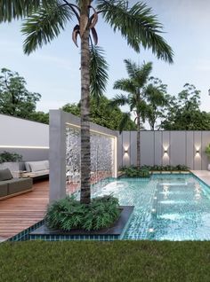 an outdoor swimming pool surrounded by palm trees and greenery, with seating area on the other side