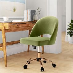 a green office chair sitting on top of a wooden floor next to a desk with a potted plant