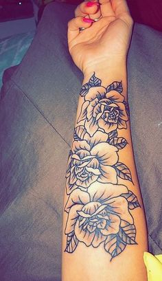 a woman's arm with flowers on it