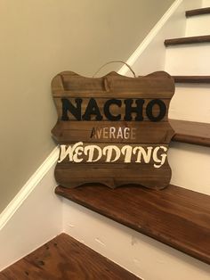 a wooden sign that says nacho average wedding on the side of a stair case