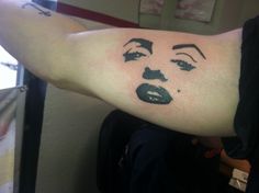 a woman's arm with a face drawn on it