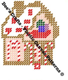 a cross stitch house with red and green dots on it's side, in the shape