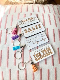 "These super cute keychains make the perfect gift for any nurse! Show your appreciation for any nurse in your life! Laser engraved with on MDF with a white painted front. Select your choice of saying and color tassel.  ♥ Dimensions: 3\" x 1.5\" ♥ Laser-engraved ♥ 1-3 day shipping" Gifts For Nurses Appreciation, Engraving Keychains With Cricut, Cricut Nurse Gifts, Nurse Personalized Gifts, Glowforge Crafts, Nurse Keychain Acrylic, Nurse Gift Ideas, Nursing Keychain, Nurse Ideas