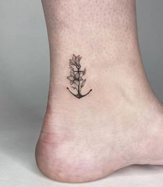 a small flower tattoo on the ankle