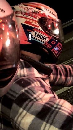 a person wearing a helmet and checkered shirt