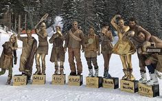 a group of people that are standing in the snow with skis on their heads