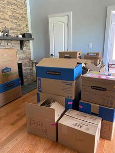 several boxes stacked on top of each other in the middle of a room with a fireplace