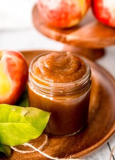 an apple and cinnamon butter on a plate with some apples in the backgroud