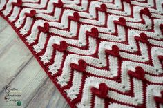 red and white crocheted afghan with hearts