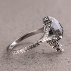 an antique style engagement ring with a fancy setting