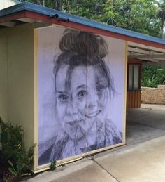 a mural on the side of a building depicting a woman's face