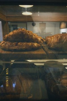 breads and pastries on display in a bakery