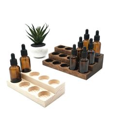 an assortment of essential oils in wooden trays next to a succulent plant