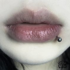 a woman's lips and nose with a piercing