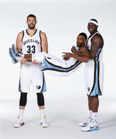 two basketball players are posing for a photo