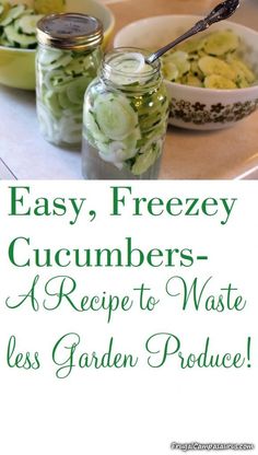 two jars filled with cucumbers sitting on top of a table next to other dishes