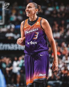 a female basketball player in purple and orange uniform