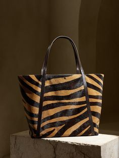 An everyday, carryall tote gets a luxurious update thanks to zebra-printed haircalf leather (also known as "pony"), constructed with plenty of room for a laptop, water bottle and all the essentials.  LEATHER WORKING GROUP: By purchasing this product, Everyday Use Zebra Print Tote Bag, Everyday Zebra Print Tote Bag, Travel Zebra Print Rectangular Bag, Rectangular Zebra Print Travel Bag, Travel Rectangular Zebra Print Bag, Haircalf Handbag, Ysl Tote Bag, Ysl Tote, Confident Outfit