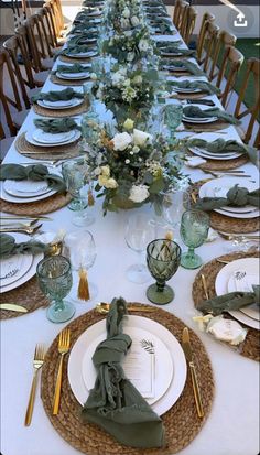 the table is set with plates and place settings