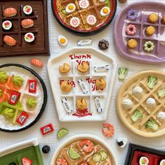 there are many different types of food on the table together, including waffles and sushi