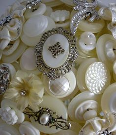 white buttons and brooches are arranged together