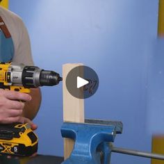 a man is using a drill to attach a piece of wood