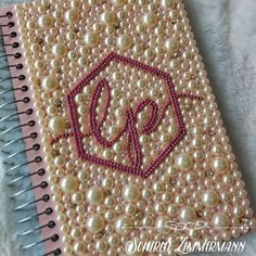 a notebook with pearls on the cover and a monogrammed letter p in it