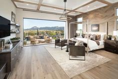 a large bedroom with wood floors and white walls, along with sliding glass doors that lead to an outdoor patio