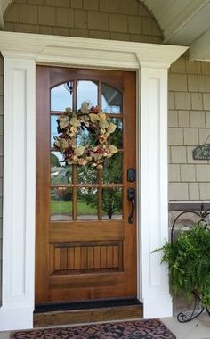 a front door with a wreath on it