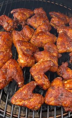 chicken wings are being cooked on the grill