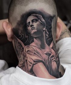 a man's head with an angel tattoo on it