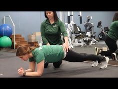 two women doing push ups in a gym