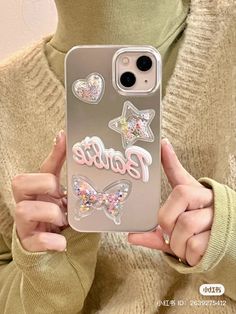 a woman holding up her phone case with glitter butterflies on it and the words barbie