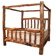 a bed made out of logs with a white pillow on the bottom and back end