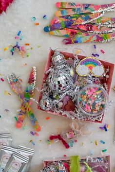 a box filled with lots of confetti on top of a white table covered in confetti