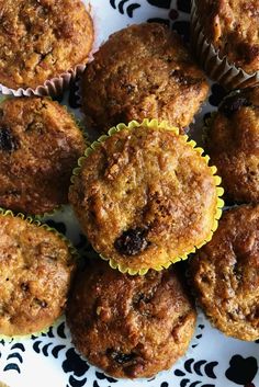 a plate full of muffins sitting on top of a blue and white table cloth