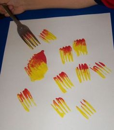 the child is drawing with colored crayons on paper and using scissors to cut them