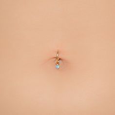 the back of a woman's stomach with a small ring on top of it