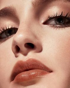 a close up shot of a woman's face with long lashes