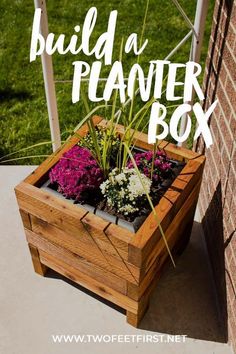 a wooden planter box with flowers in it and the words build a planter box above it