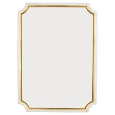 a white and gold framed mirror on a white wall with an ornate border around the edges